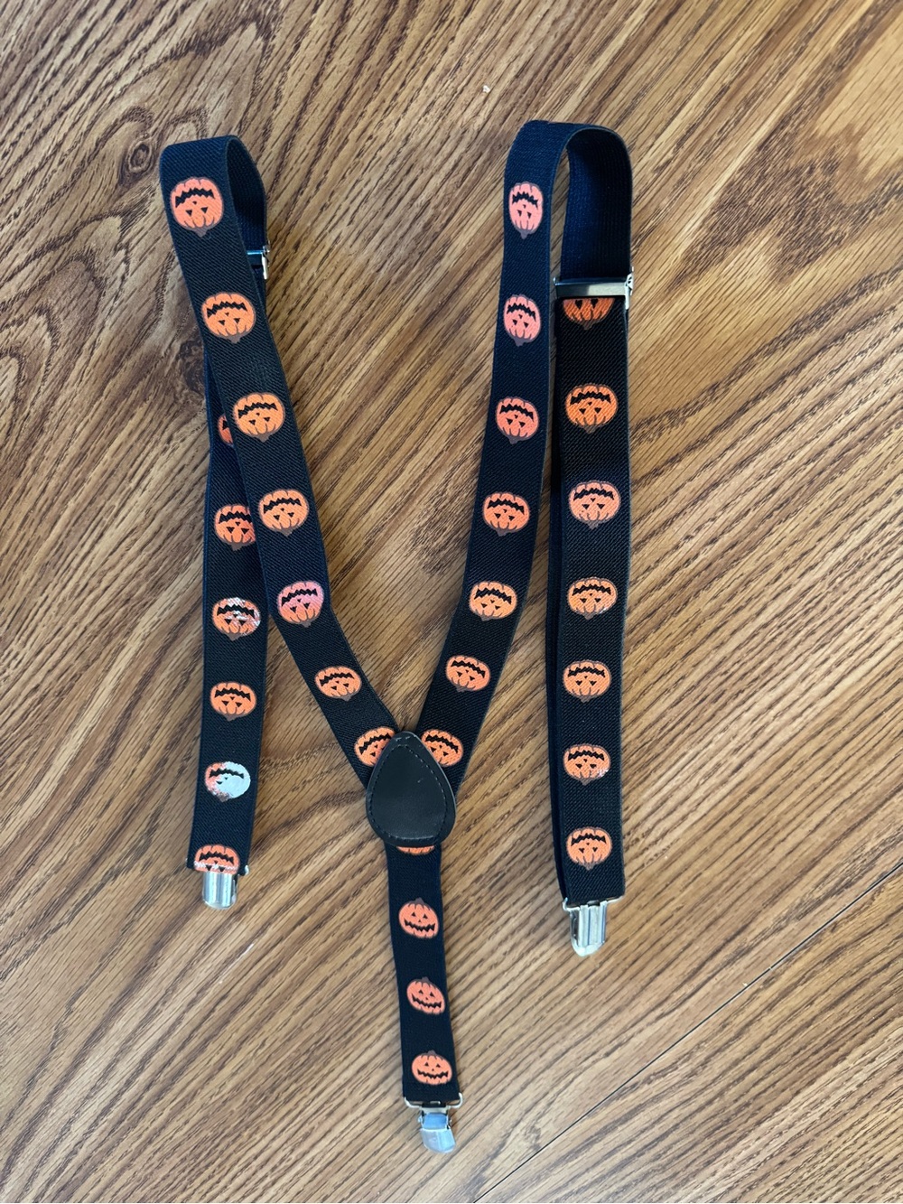 halloween novelty suspenders featuring an orange jack-o'-lantern pumpkin pattern
